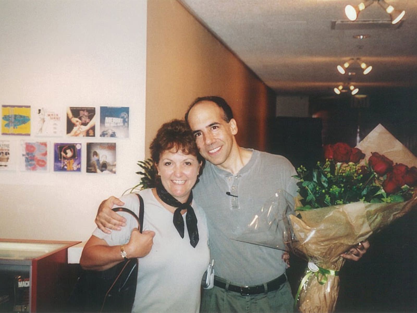 Chaz Esposito holding a bouquet of roses beside a guest after a performance
